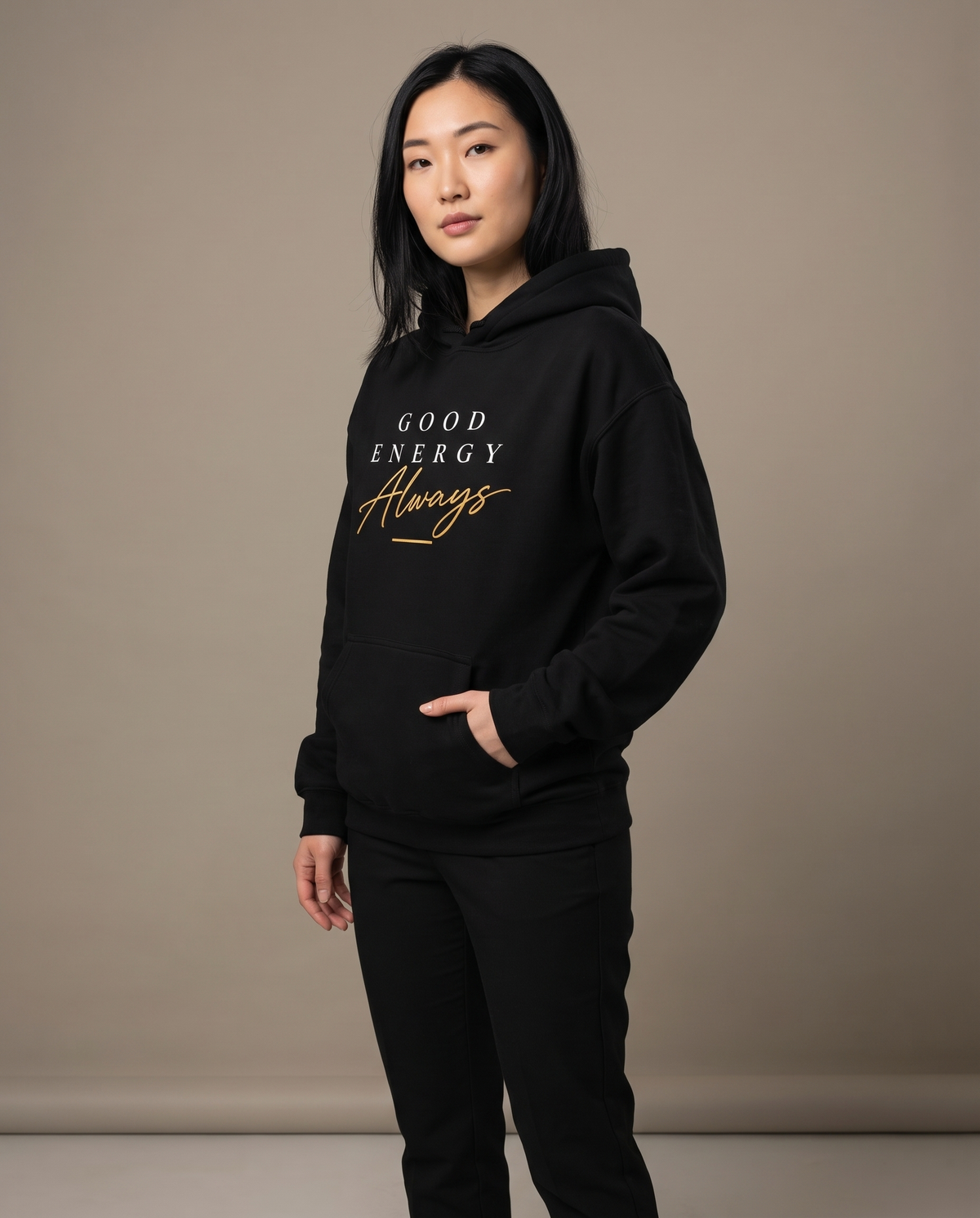 Model wearing the Landells Good Energy Hoodie, studio three-quarter front view