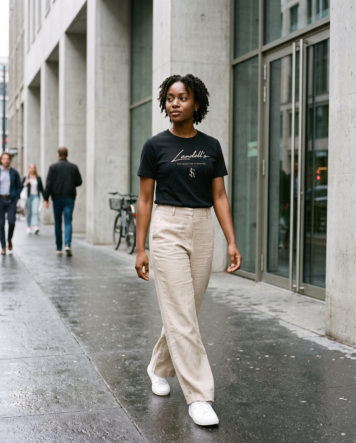 Model wearing the Landells Tee in black, street style walking