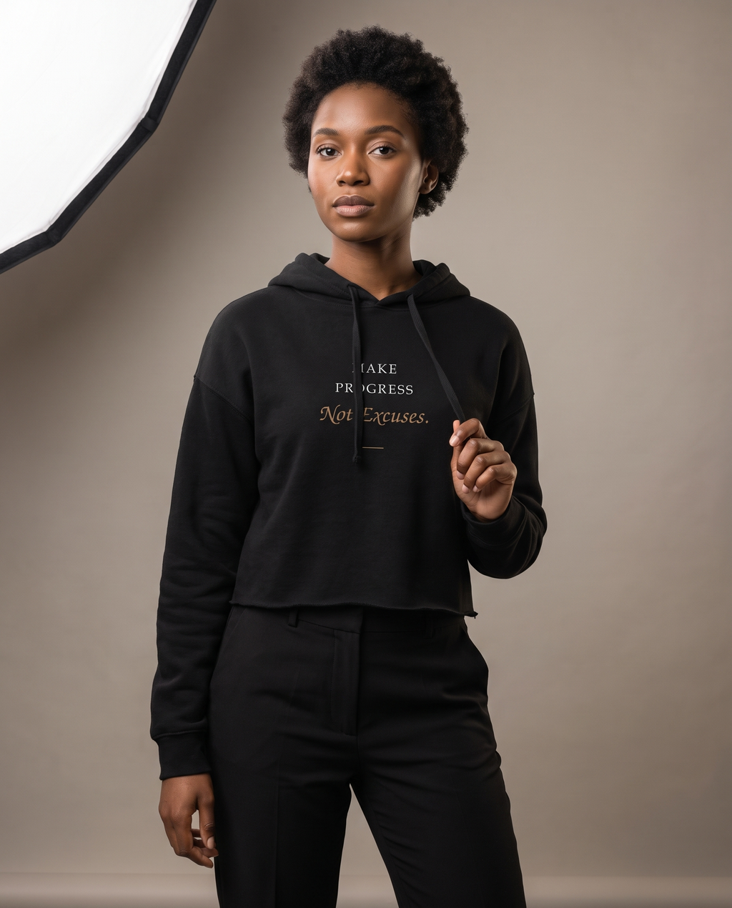 Model wearing the Landells Make Progress Crop Hoodie, studio three-quarter front view