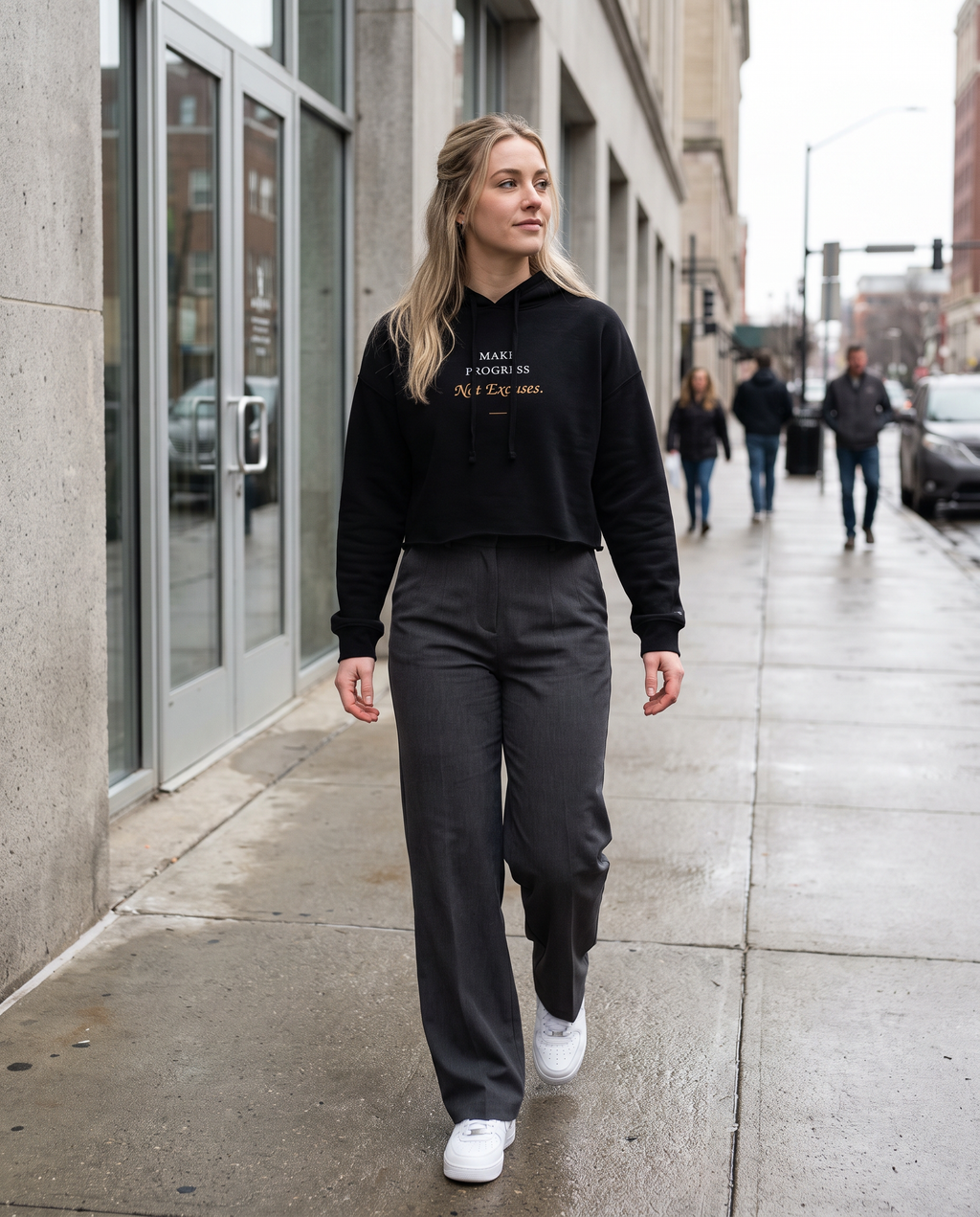 Model wearing the Landells Make Progress Crop Hoodie, street style walking