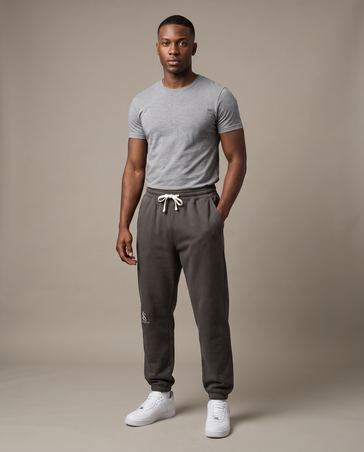 Model wearing the Landells Fleece Sweatpants in pepper, studio three-quarter front view