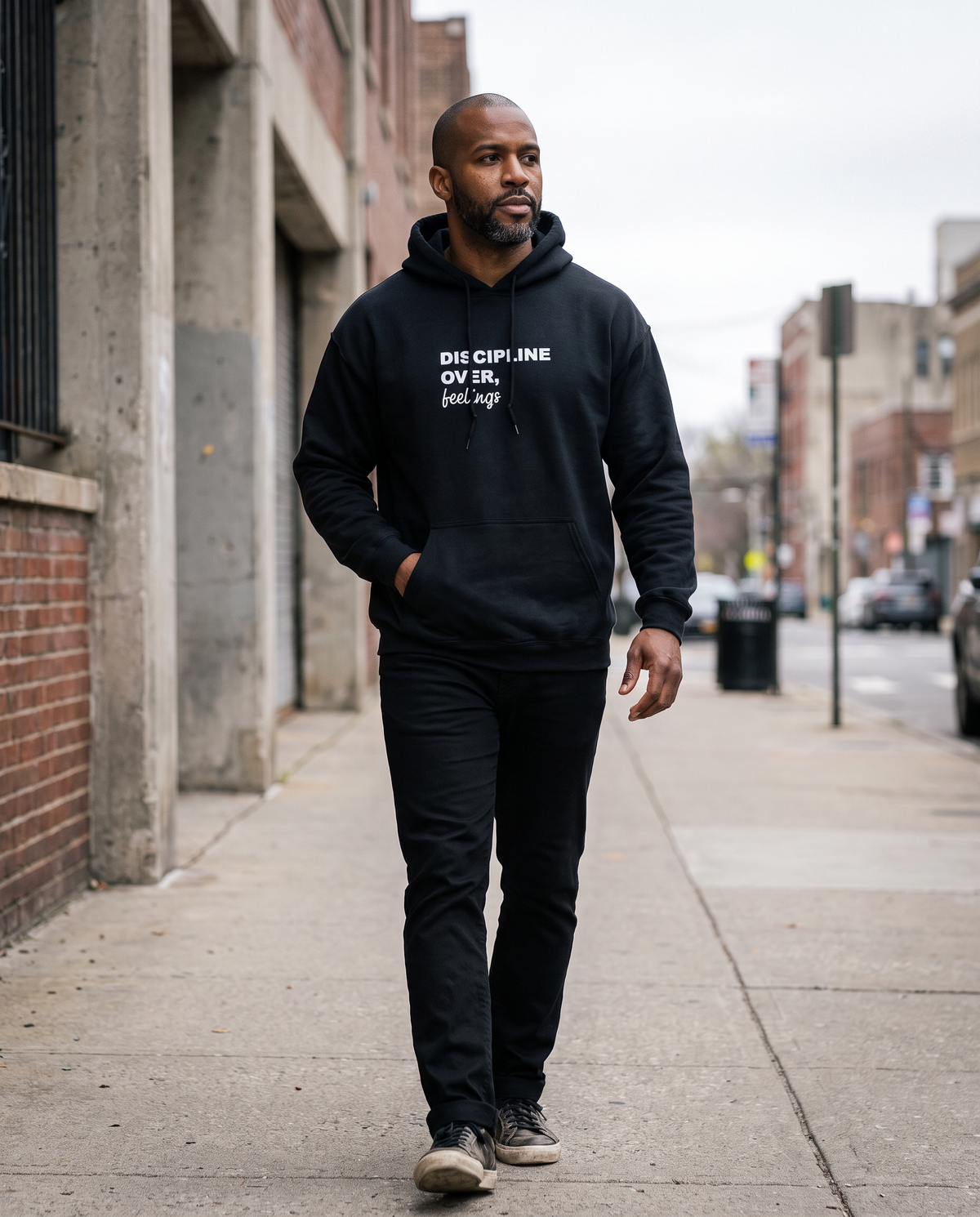 Discipline Over Feelings Hoodie worn walking on a city street