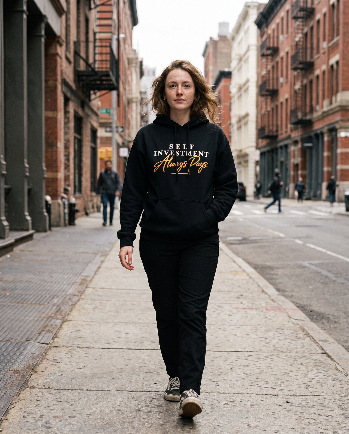 Self Investment Hoodie worn walking on a city street