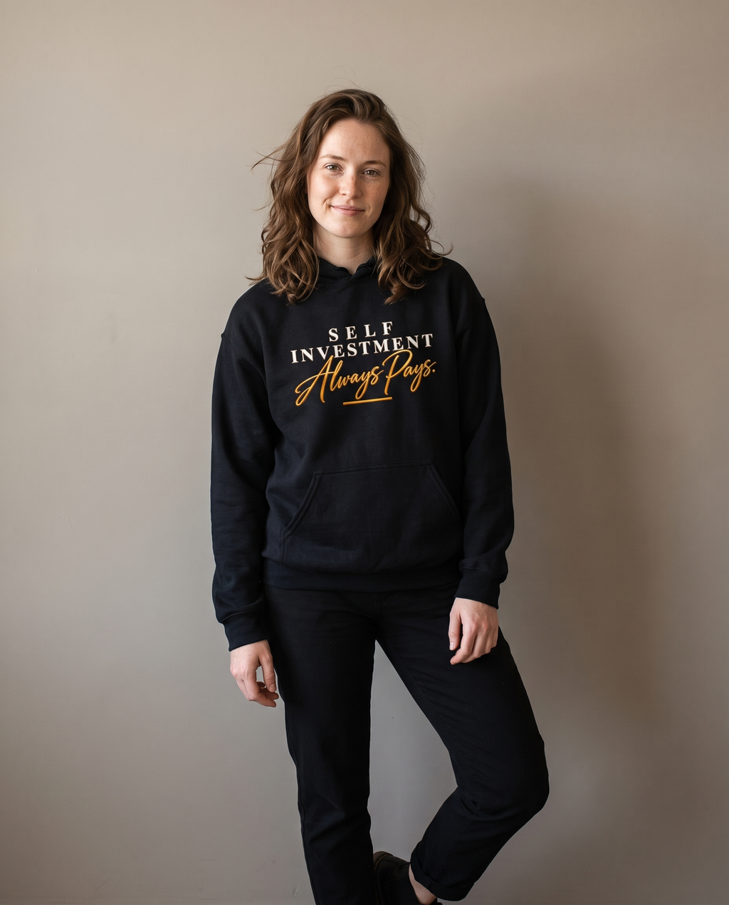 Self Investment Hoodie worn by a woman, studio front view