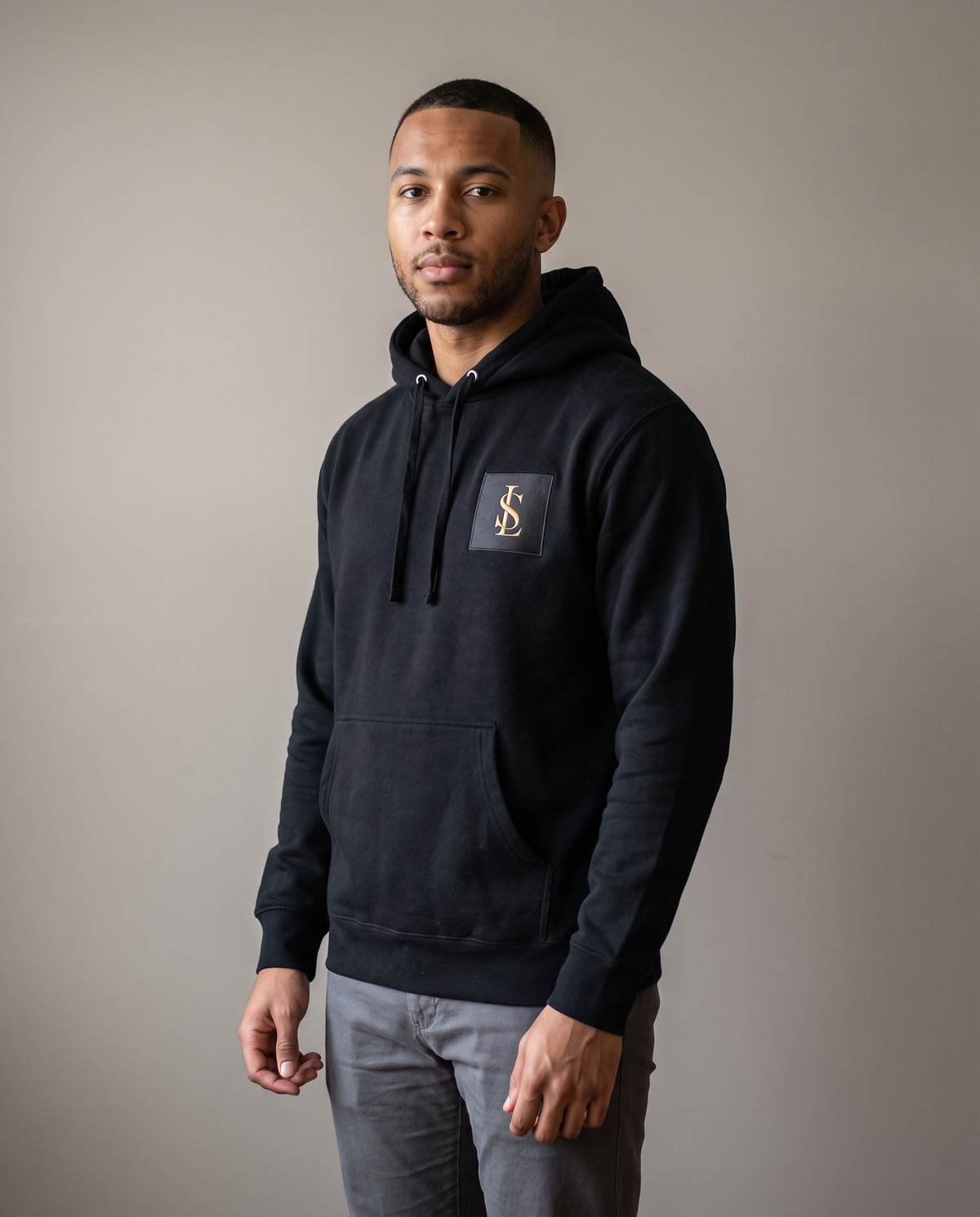 Heavyweight Hoodie in black worn by a man, studio view