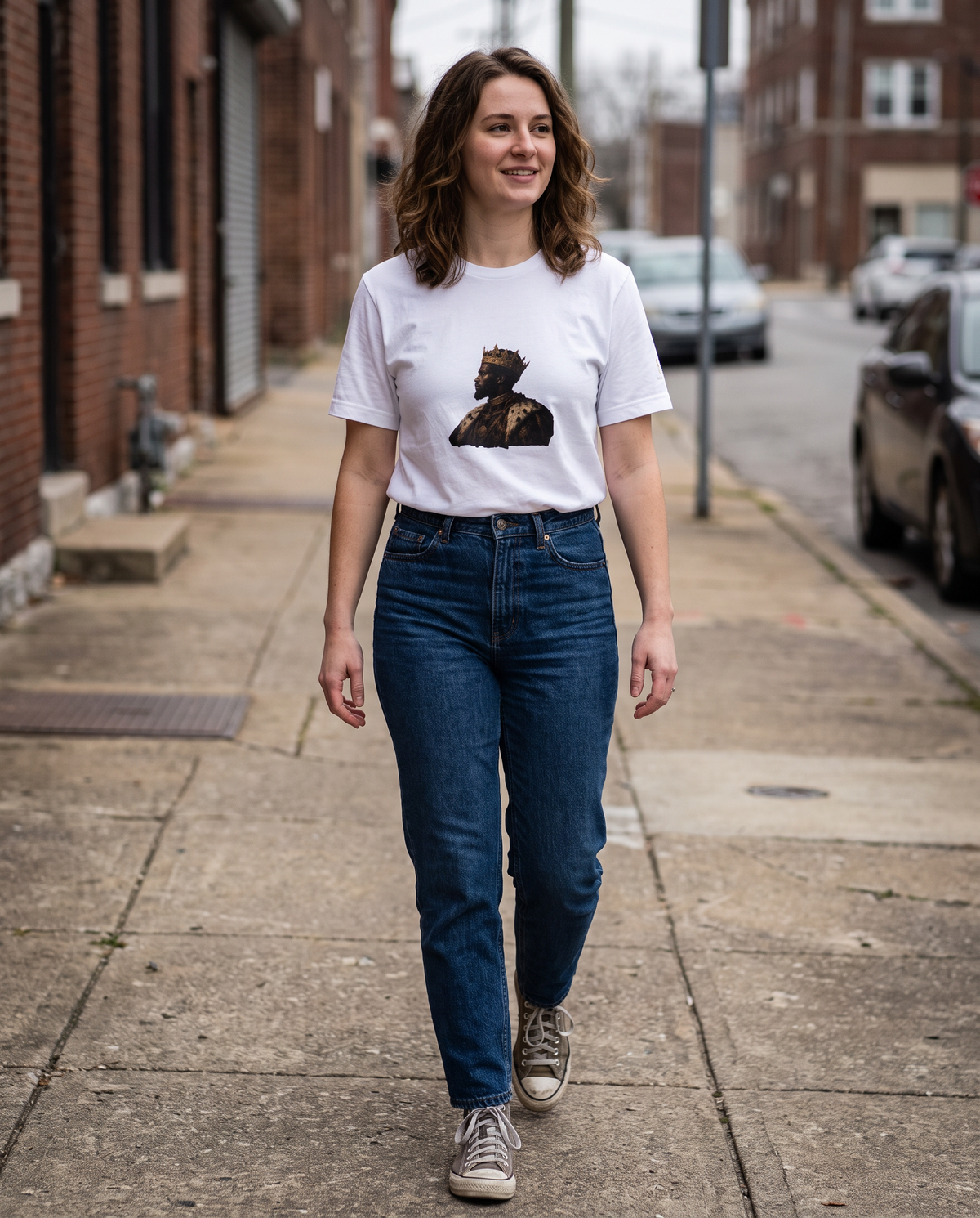 Essential Tee in white worn walking on a city street