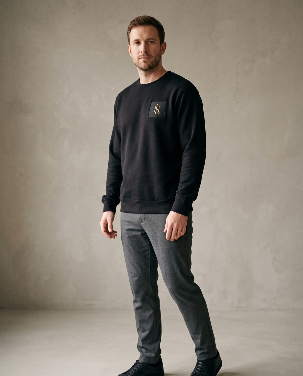 Fleece Crew Sweatshirt in black worn by a man, studio view