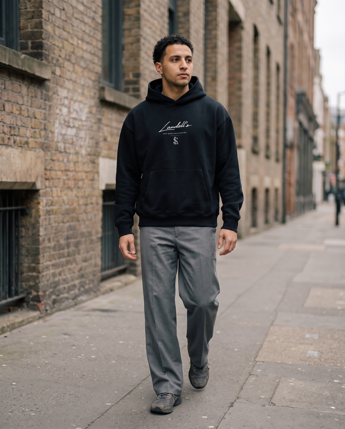 Oversized Hoodie in black worn walking on a city street