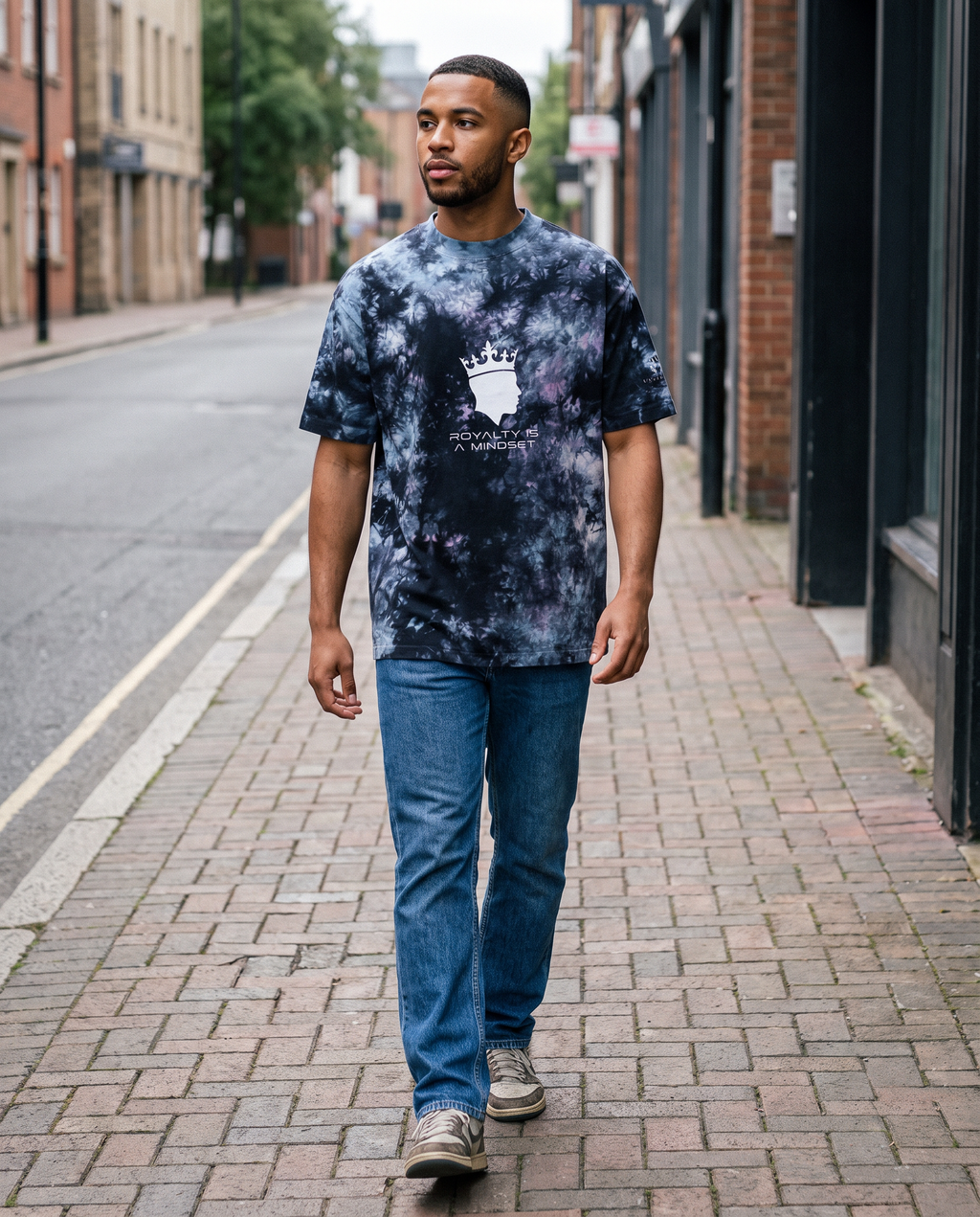 Man wearing the Royalty Is a Mindset tie-dye tee, street style
