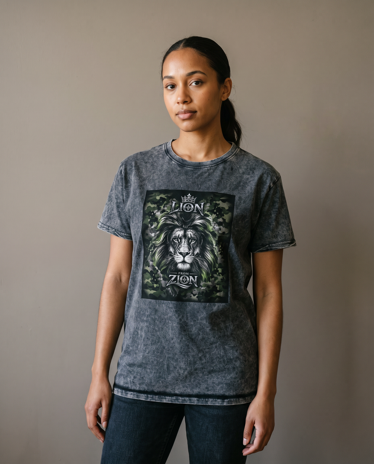 Woman wearing the Lion From Zion acid-wash denim tee, studio